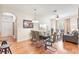 Open dining area with modern table setting next to the living room with a hardwood floor at 4114 Breakview Dr # 110, Orlando, FL 32819