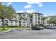 Well-maintained apartment building exterior with balconies, landscaping, and convenient parking spaces at 4114 Breakview Dr # 110, Orlando, FL 32819