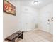 Hallway view with tile flooring, a storage closet, and a bench for convenience at 4114 Breakview Dr # 110, Orlando, FL 32819