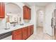 Spacious kitchen with wooden cabinetry, white countertops and modern stainless steel appliances at 4114 Breakview Dr # 110, Orlando, FL 32819
