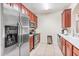 Kitchen with stainless steel appliances, wooden cabinets, and tile flooring and a breakfast bar area at 4114 Breakview Dr # 110, Orlando, FL 32819