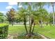 Beautiful landscaping with palm trees, greenery, and red flowers creates a lush and inviting outdoor space at 4114 Breakview Dr # 110, Orlando, FL 32819