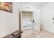 Functional laundry room with washer, dryer, ironing board, bench, and convenient storage space at 4114 Breakview Dr # 110, Orlando, FL 32819
