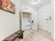 Functional laundry room with washer, dryer, ironing board, bench, and convenient storage space at 4114 Breakview Dr # 110, Orlando, FL 32819