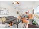Open-concept living room with a gray sofa, modern furniture, and a dining area with a view of the kitchen at 4114 Breakview Dr # 110, Orlando, FL 32819