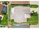 Aerial view showcasing the home's roof, landscaping, driveway, and proximity to neighboring houses at 449 Timmonsville Way, The Villages, FL 32162