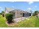 Backyard features a screened-in patio offering ample outdoor space and grass at 449 Timmonsville Way, The Villages, FL 32162