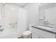 Bathroom features a shower-tub combo with gray countertop vanity and white cabinets at 449 Timmonsville Way, The Villages, FL 32162