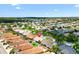 Wide aerial view of a residential community filled with palm trees and well-kept landscaping at 449 Timmonsville Way, The Villages, FL 32162