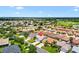 Aerial view of a residential community with a golf course and pond in the distance at 449 Timmonsville Way, The Villages, FL 32162
