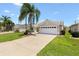 Charming single-story home featuring a well-maintained lawn and a two-car garage, offering curb appeal and convenience at 449 Timmonsville Way, The Villages, FL 32162
