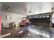 Garage features a clean epoxy floor, garage door and a red golf cart at 449 Timmonsville Way, The Villages, FL 32162