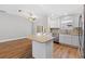 Bright open-concept kitchen featuring stainless steel appliances and an island at 449 Timmonsville Way, The Villages, FL 32162