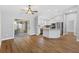 Open-concept living space with modern flooring and stainless steel appliances, creating a welcoming atmosphere at 449 Timmonsville Way, The Villages, FL 32162