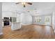 Bright living area with modern flooring, stainless steel appliances, and a kitchen island, perfect for gathering at 449 Timmonsville Way, The Villages, FL 32162