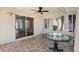 Covered patio features tile flooring, ceiling fan, and sliding glass doors at 449 Timmonsville Way, The Villages, FL 32162