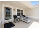Relaxing front patio with seating, offering a comfortable outdoor space to enjoy the neighborhood views at 449 Timmonsville Way, The Villages, FL 32162