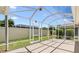 Screened patio overlooking backyard, featuring ample space and clear skies at 449 Timmonsville Way, The Villages, FL 32162
