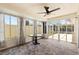 Sun room offers tile flooring, glass windows and a black table at 449 Timmonsville Way, The Villages, FL 32162