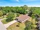 High angle shot of the home showing the roof, a long driveway and surrounding trees at 458 Spring Ln, Ocala, FL 34472