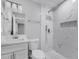 Bathroom features shower over tub with white marble-style tile, and modern vanity at 458 Spring Ln, Ocala, FL 34472