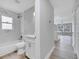 This bathroom features shower over tub with white marble-style tile, and modern vanity at 458 Spring Ln, Ocala, FL 34472