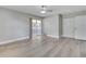 Spacious bedroom featuring a ceiling fan, sliding glass doors, and light wood flooring at 458 Spring Ln, Ocala, FL 34472