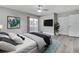 Bright bedroom with a ceiling fan, hardwood floors, and balcony access for enjoying outdoor relaxation at 458 Spring Ln, Ocala, FL 34472