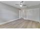 This bedroom features a ceiling fan, closet, and light wood flooring at 458 Spring Ln, Ocala, FL 34472