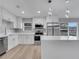 Modern white kitchen with stainless steel appliances, plenty of cabinets and breakfast bar, perfect for cooking at 458 Spring Ln, Ocala, FL 34472