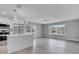 Open-concept living space with modern white cabinets, stainless steel appliances, and hardwood flooring at 458 Spring Ln, Ocala, FL 34472