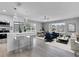 Open-concept living room with an island kitchen, modern lighting, and dining area with lots of natural light at 458 Spring Ln, Ocala, FL 34472