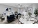 Bright living room showcases modern furniture, an elegant dining table, and seamless flow to the kitchen at 458 Spring Ln, Ocala, FL 34472