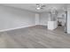 Inviting open concept living and kitchen area with modern lighting, light gray walls and hardwood flooring at 458 Spring Ln, Ocala, FL 34472