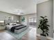 Serene main bedroom featuring a large bed, sliding glass doors, and tranquil decor at 458 Spring Ln, Ocala, FL 34472