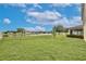 This backyard features a pond view, landscaping and a screened-in patio at 4901 Stone Acres Cir, St Cloud, FL 34771