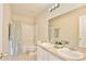 Well-lit bathroom with a dual sink vanity and a shower-tub combination, creating a practical and inviting space at 4901 Stone Acres Cir, St Cloud, FL 34771