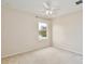 Bright bedroom with scenic lake view, featuring plush carpet, a ceiling fan, and natural light at 4901 Stone Acres Cir, St Cloud, FL 34771