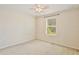 This bedroom features neutral carpeting and a window with blinds at 4901 Stone Acres Cir, St Cloud, FL 34771