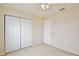 This bedroom features neutral carpeting, a ceiling fan and large double door closet at 4901 Stone Acres Cir, St Cloud, FL 34771