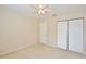 This bedroom features neutral carpeting, a ceiling fan and a double door closet at 4901 Stone Acres Cir, St Cloud, FL 34771