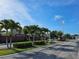 View of the community entrance with brick accents and palm trees at 4901 Stone Acres Cir, St Cloud, FL 34771