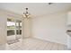 Bright dining area with tile floors, an elegant chandelier, and sliding door leading to the patio at 4901 Stone Acres Cir, St Cloud, FL 34771