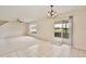 Open dining area featuring tile flooring, chandelier, and sliding glass door access to the outside patio at 4901 Stone Acres Cir, St Cloud, FL 34771