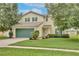 Charming two-story home with a well-maintained lawn and mature trees offering curb appeal at 4901 Stone Acres Cir, St Cloud, FL 34771