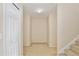 Neutral hallway featuring carpeted floor, stairs, and a closet, showcasing a clean and functional transition space at 4901 Stone Acres Cir, St Cloud, FL 34771