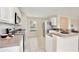 Efficient kitchen featuring white cabinets, stainless steel appliances, and tile flooring at 4901 Stone Acres Cir, St Cloud, FL 34771