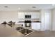 Well-lit kitchen with white cabinets, modern appliances, and ample counter space for meal preparation at 4901 Stone Acres Cir, St Cloud, FL 34771