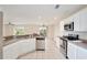 Modern kitchen featuring stainless steel appliances, white cabinets, and tile flooring at 4901 Stone Acres Cir, St Cloud, FL 34771