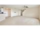 Large living room with carpet flooring and neutral walls leading to the stairway and additional rooms at 4901 Stone Acres Cir, St Cloud, FL 34771